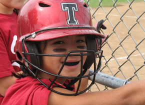 girl wearing mouthguard at baseball game